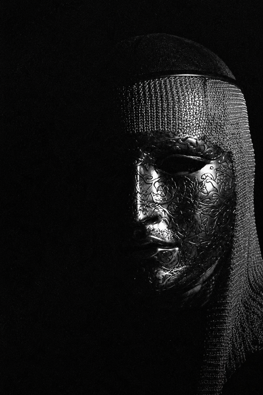 Visage masqué dans l'ombre, photographie en noir et blanc